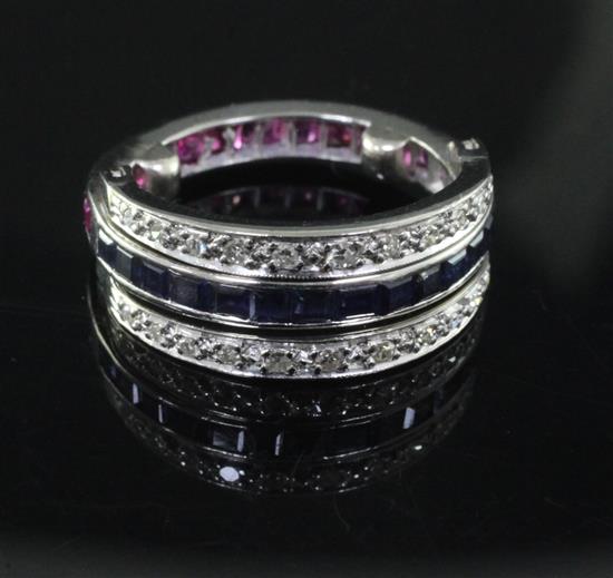 A white gold, ruby, sapphire and diamond set triple band swivel ring, size J.